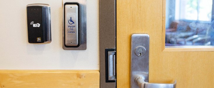 9cfad44b878c94cce3e9e5e476952758 A closeup image of door handle and button for accessible entry
