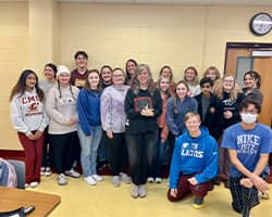 a group of students posing for a photo with their professor