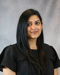 Headshot for Uzma Bejna wearing a black top.