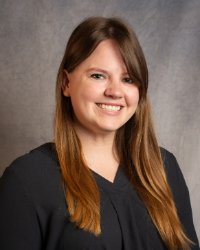 A woman with a black shirt and long hair.