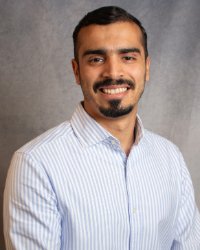 A man wearing a blue and white striped shirt.