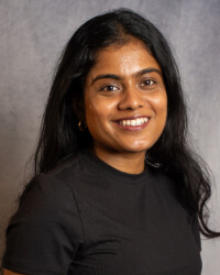 A woman in a black shirt, smiling.