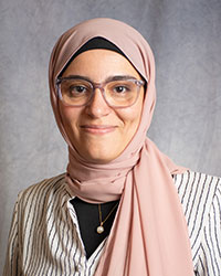 Aboualla,-Doaa-web Doaa Aboualla is wearing glasses and a pink headscarf