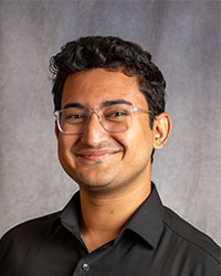 Syed Ali is wearing glasses and a black shirt