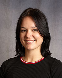 Nicole Ireland is wearing a black shirt and has short black hair.