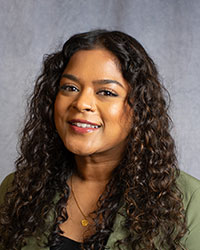 Velu, Shaylene Shaylene Velu is wearing a green blazer with a black top.