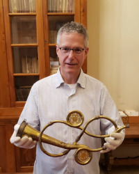 CMU Trumpet Professor holding a trumpet crafted for Cesare Bendinelli, the author of the first treatise on trumpet performance.