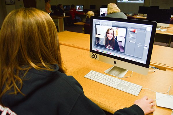 a student works on an advertising project during class