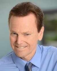 Headshot of Brad Slaight. He's wearing a blue shirt and tie.