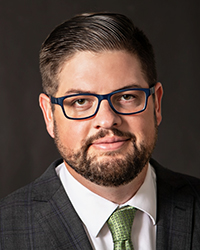 Headshot of Chad Livengood with a dark grey backdrop.