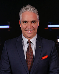 Headshot of Matt Shepard. He's dressed in a dark blue suit.