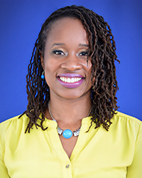 Headshot of Talia Brookshire on a bright blue backdrop.