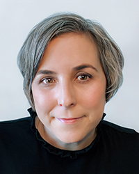 Headshot of Tricia Hoover on a light grey backdrop.