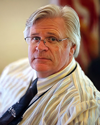 Headshot of Rick McKay. He's wearing a dress shirt and tie.