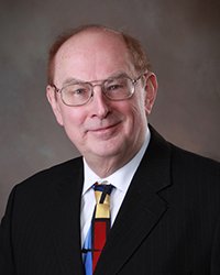 Headshot of Peter Orlik set in front of a dark grey backdrop.