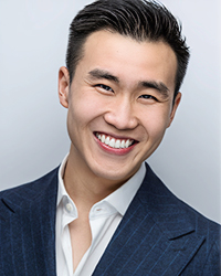 Headshot of Brandon Chu on a soft grey backdrop.