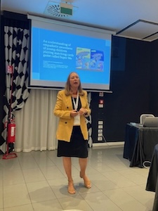 Professor Nowak-Fabrykowski presenting with a screen behind her at the OMEP Conference.