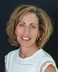Professional headshot of Heather Maietta against a dark blue background.