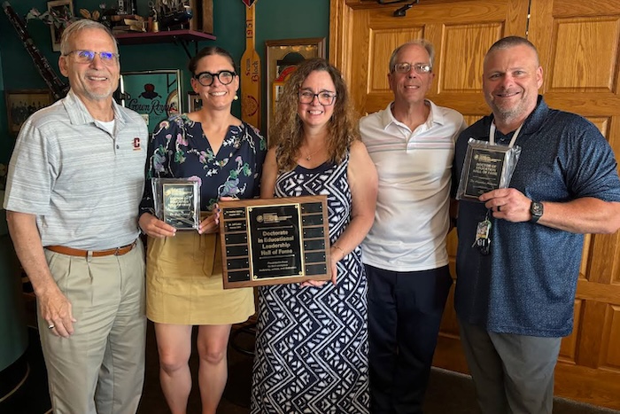 Faculty posing with the Award plaques at the Hall of Fame Awards ceremony.
