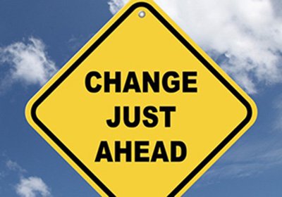 Image of yellow road sign with the words Change Just Ahead