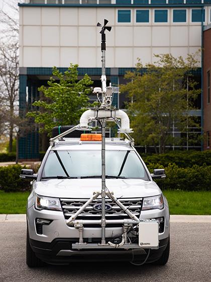 A view of the front of a vehicle with a large amount of weather measuring equipment attached to it.