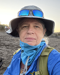 A woman wearing a hat and sunglasses.