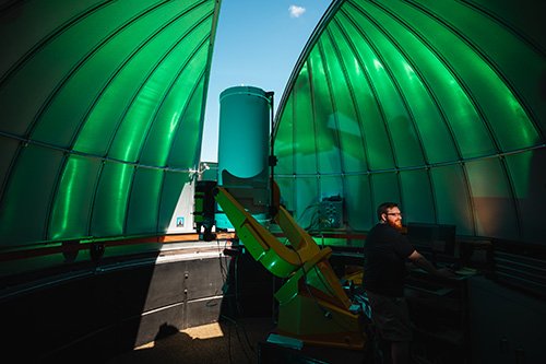 Astronomy student entering data in the telescope room on top of Brooks Hall