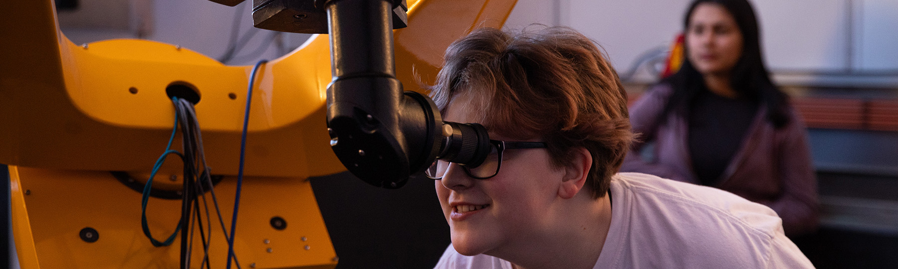 A person looking through a telescope