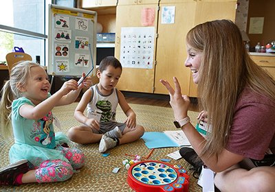 A student interacting with two children
