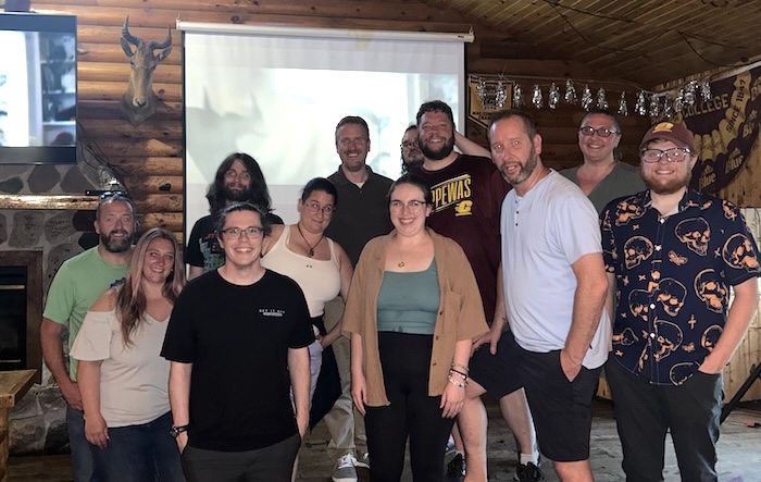 Group photo of OIT staff, partners, and guests after winning a trivia contest.