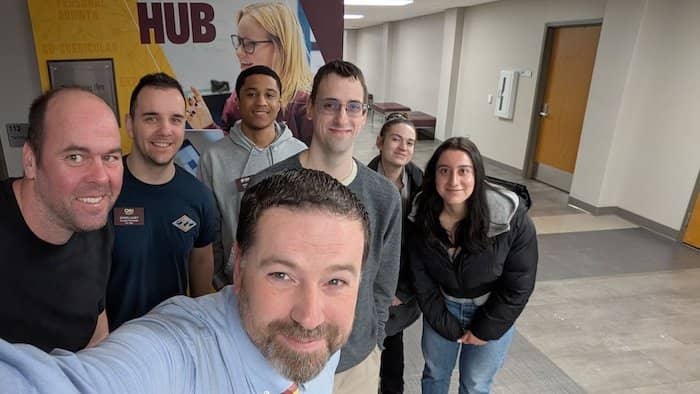 Seven OIT team members pose for a group selfie in Grawn Hall.