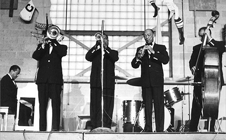 Black and white photo of a group of men playing instruments.