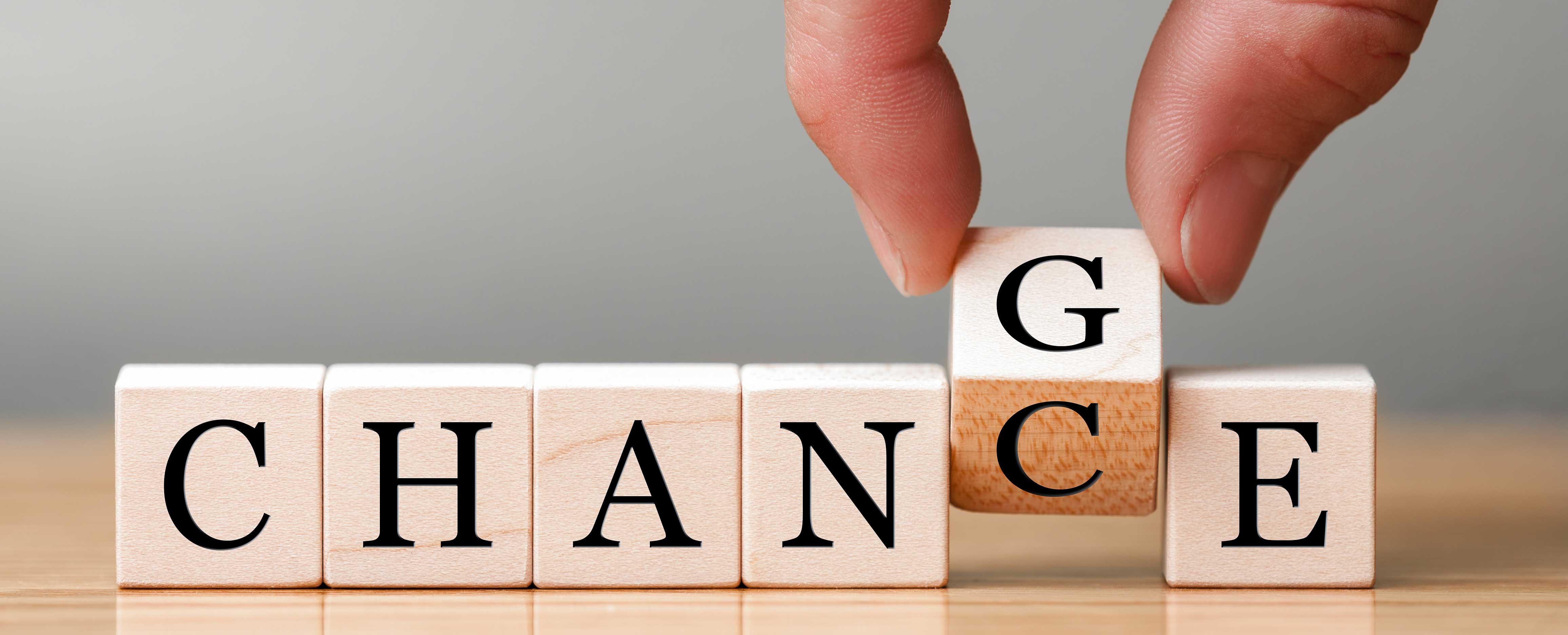 The word change spelled out in wooden letter blocks