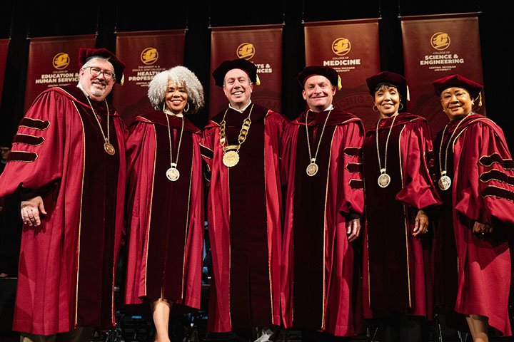 a group of people wearing graduation gowns and robes