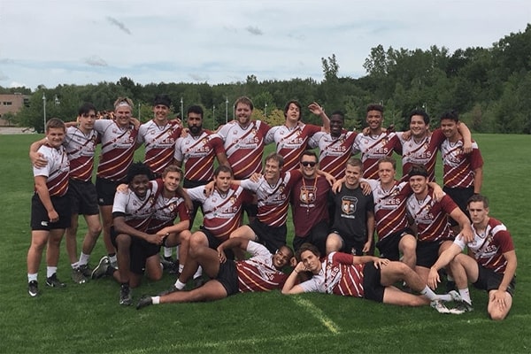 Group photo of the club sports soccer team on the field.
