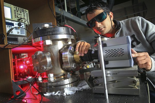 CMU physics student working with some equipment