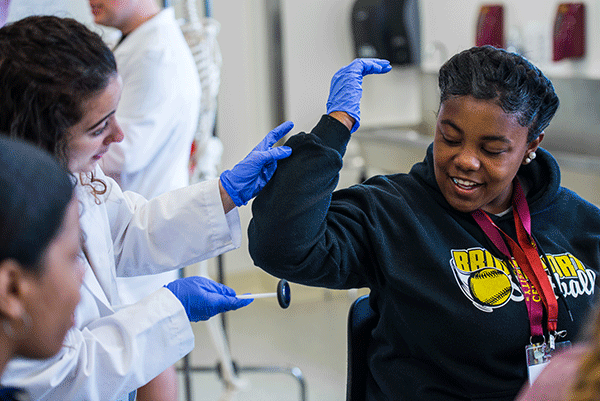 CollegeHealth students trying to examine other student hitting on their elbow
