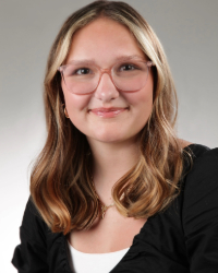 Paityn a woman wearing glasses and smiling