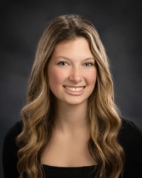 Jaclyn Headshot A woman with long blonde hair, smiling for a professional headshot.