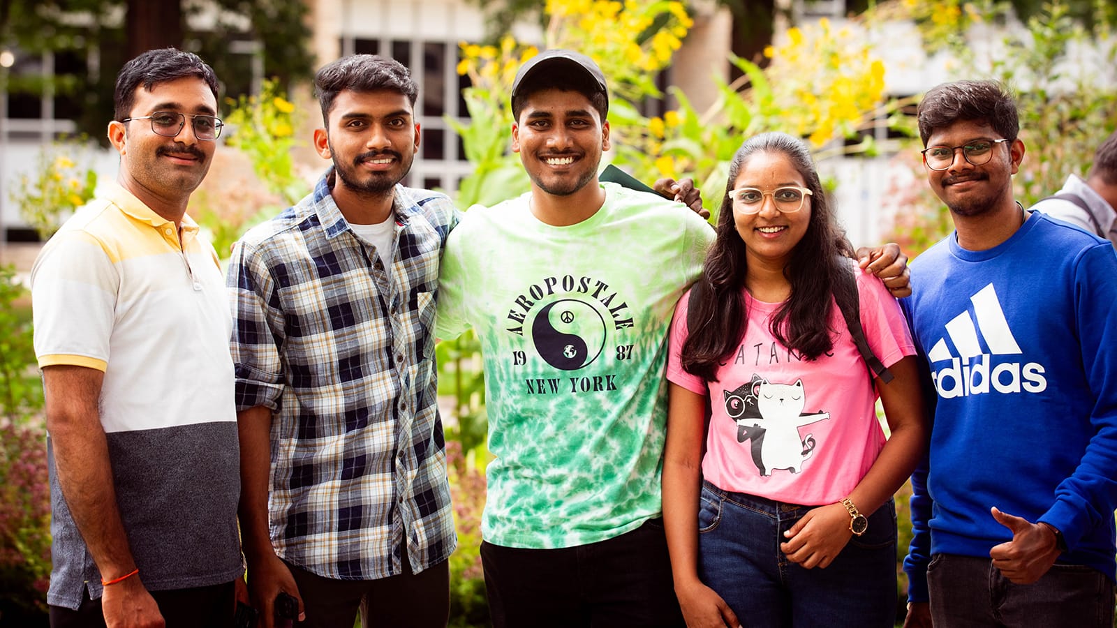 A group of international students stand together at the international student orientation event.