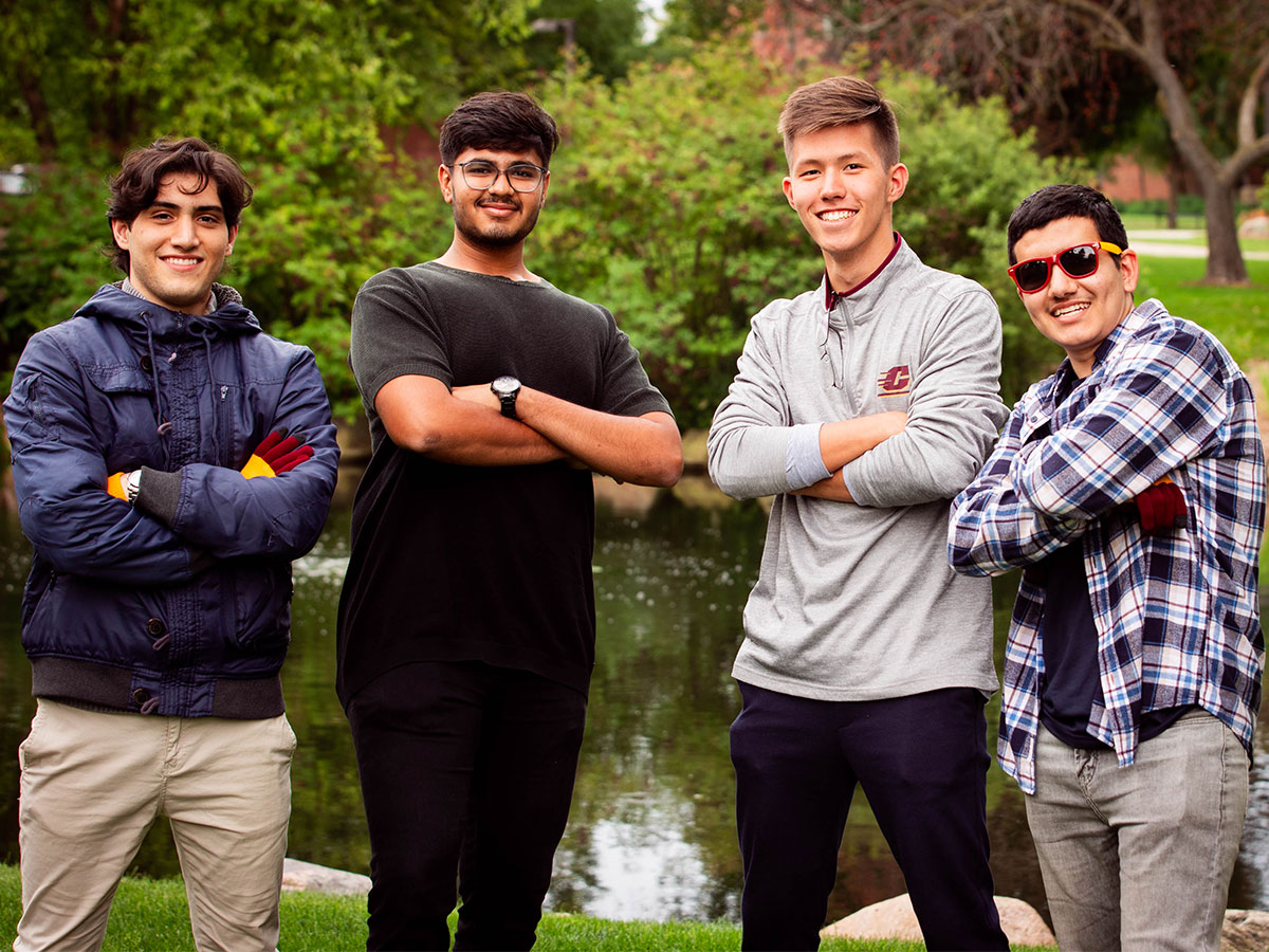 A diverse group of four men during international orientation