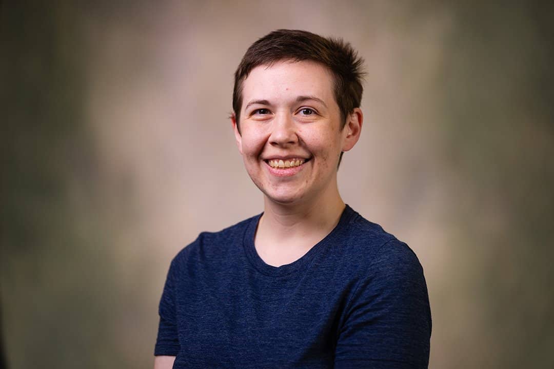 Professional headshot of Hannah Amerson wearing a dark blue shirt while looking at the camera.