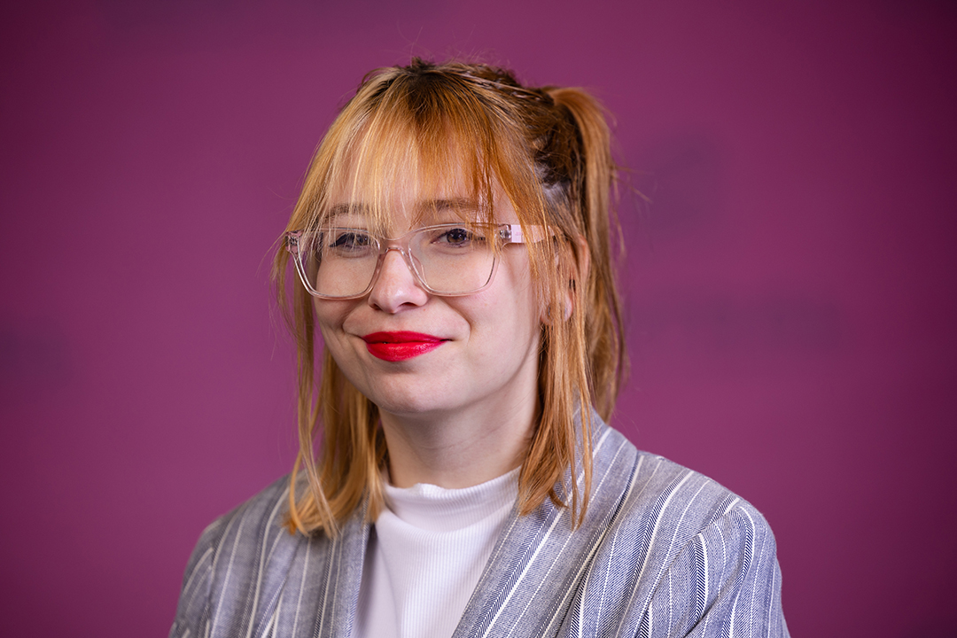 Professional headshot of Alyxczia Thurlow wearing a blue and white striped blazer with white shirt while looking at the camera.