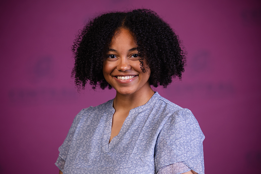 Professional headshot of Zaida Gromko wearing a blue flora blouse while looking at the camera.