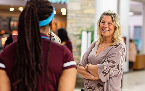 a supporter talking to an orientation student mentor at orientation