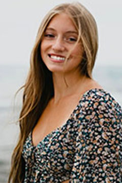 CarlyRamoforWeb A photo of SI Leader, Carly Ramo, posing outdoors in front of a body of water