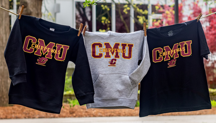 Three CMU Chippewas apparel items, from the CMU Bookstore, hanging on a clothesline outdoors.