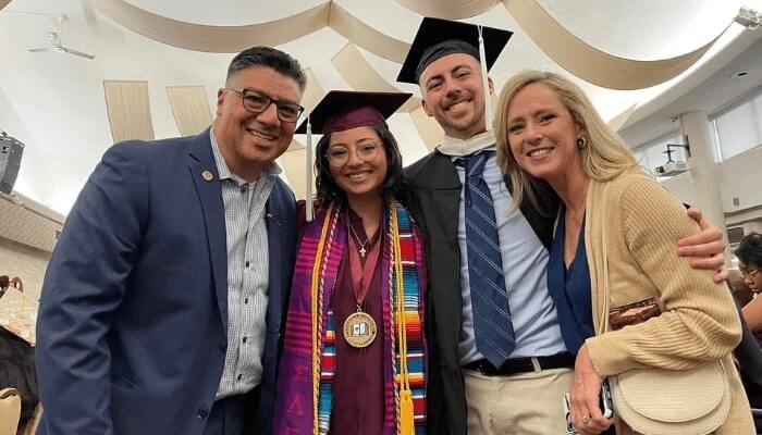 Four individuals, two in CMU graduation caps, at the Multicultural Academic Student Services Celebratory Graduation event.
