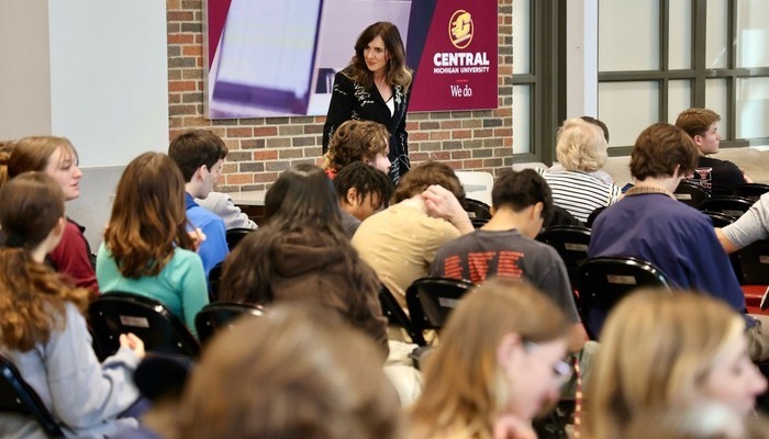 A professor presenting to a seated audience of students at Central Michigan University.