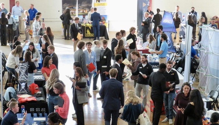A CMU career fair inside Finch Fieldhouse with numerous students and recruiters at tables.